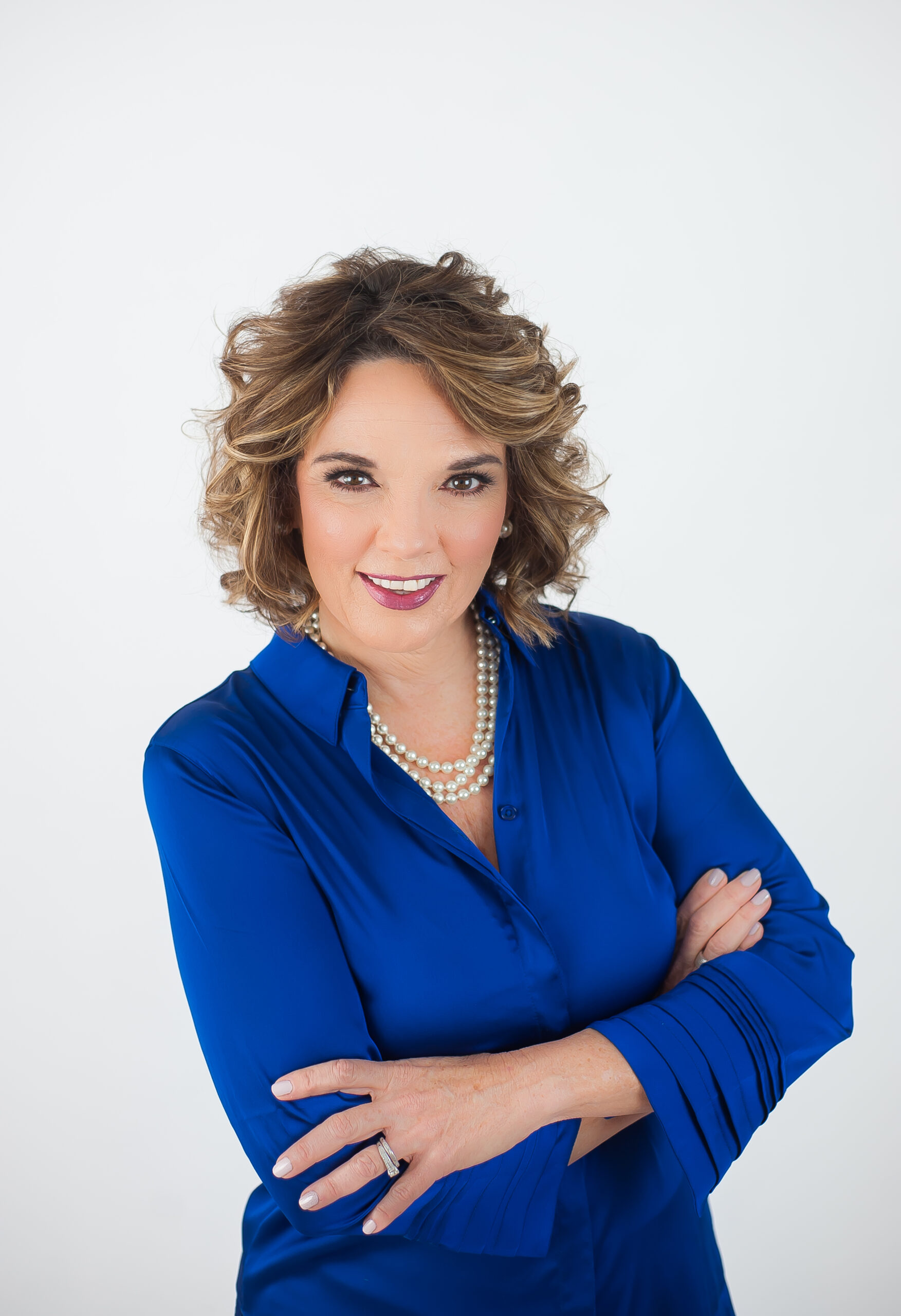 Colene Rogers Blue Dress White Background Arms Crossed